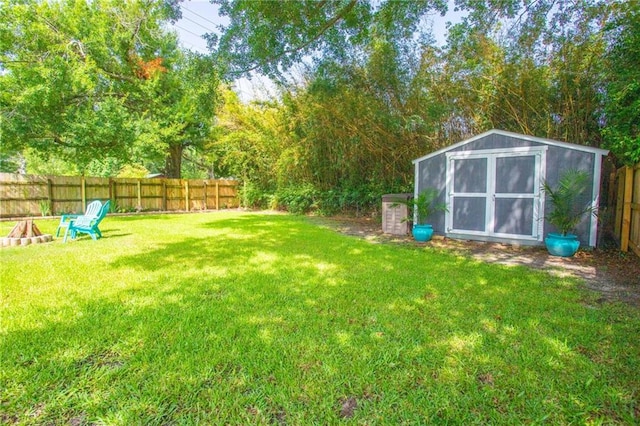3039 College St, Slidell, LA 70458 - fenced backyard with a storage unit and a fire pit