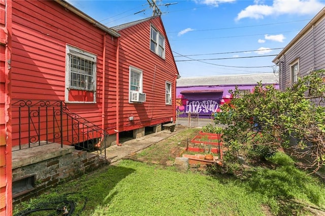 71113 Montegut St, New Orleans, LA 70117 - view of side of property featuring a yard and cooling unit