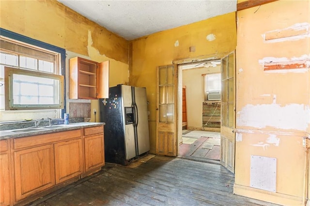 71113 Montegut St, New Orleans, LA 70117 - kitchen featuring refrigerator with ice dispenser, dark wood-style flooring, brown cabinets, open shelves, and cooling unit