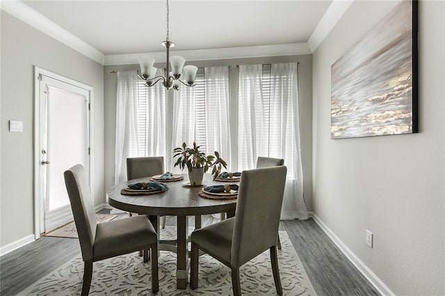 5681 Oakworth St, Slidell, LA 70461 - dining space with a chandelier, wood finished floors, and crown molding