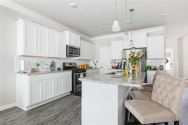5681 Oakworth St, Slidell, LA 70461 - kitchen with appliances with stainless steel finishes, tasteful backsplash, a kitchen island with sink, a breakfast bar area, and hanging light fixtures