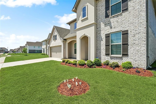 5681 Oakworth St, Slidell, LA 70461 - view of front of home with driveway, brick siding, a garage, a front yard, and a residential view