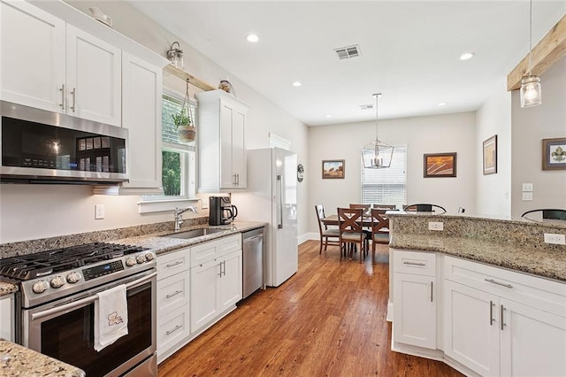 53131 S Bennett Rd, Independence, LA 70443 - kitchen with stainless steel appliances, plenty of natural light, white cabinetry, and recessed lighting