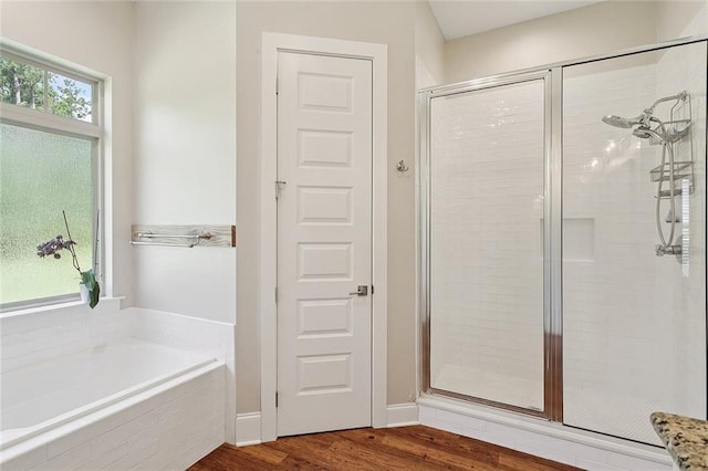 53131 S Bennett Rd, Independence, LA 70443 - full bath with a shower stall, a bath, and wood finished floors