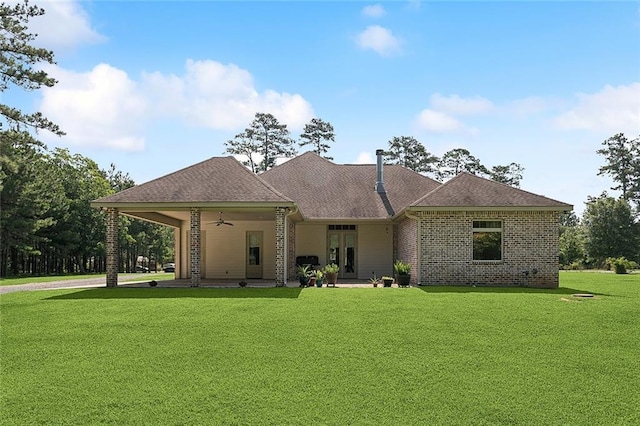 53131 S Bennett Rd, Independence, LA 70443 - back of property featuring a lawn, ceiling fan, brick siding, a patio area, and roof with shingles