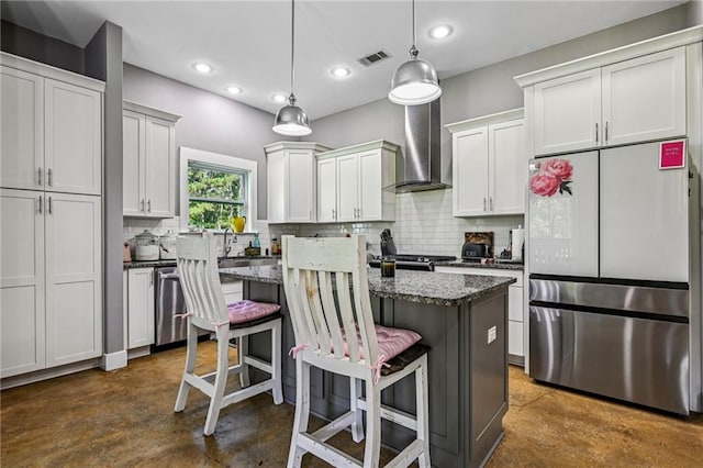 22101 Fletcher Rd, Ponchatoula, LA 70454 - kitchen featuring appliances with stainless steel finishes, concrete floors, a center island, tasteful backsplash, and recessed lighting