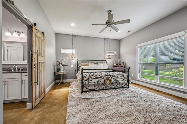 22101 Fletcher Rd, Ponchatoula, LA 70454 - bedroom with a barn door, recessed lighting, concrete floors, and a ceiling fan