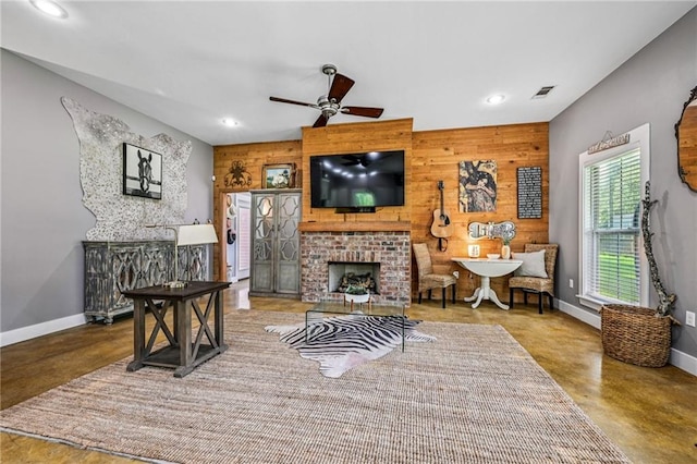 22101 Fletcher Rd, Ponchatoula, LA 70454 - living room with concrete flooring, wooden walls, a brick fireplace, recessed lighting, and ceiling fan