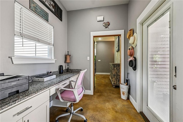 22101 Fletcher Rd, Ponchatoula, LA 70454 - home office featuring built in desk and finished concrete floors