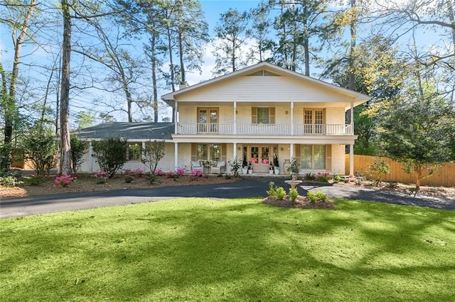 163 Tchefuncte Dr, Covington, LA 70433 - view of front of home featuring brick siding, covered porch, french doors, and driveway
