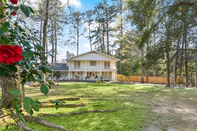 163 Tchefuncte Dr, Covington, LA 70433 - rear view of house with a porch, a chimney, and a balcony