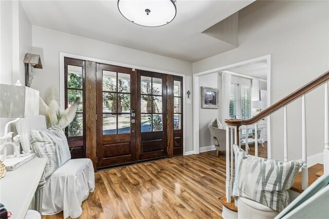 163 Tchefuncte Dr, Covington, LA 70433 - entryway featuring french doors, plenty of natural light, wood finished floors, and stairway