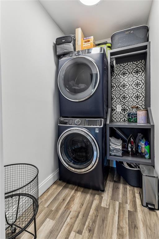163 Tchefuncte Dr, Covington, LA 70433 - laundry room with stacked washer / drying machine and wood finished floors