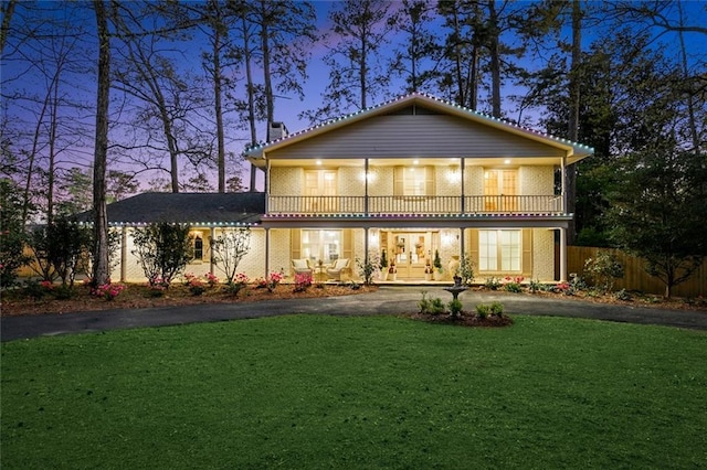 163 Tchefuncte Dr, Covington, LA 70433 - back of house with a balcony, driveway, and a chimney