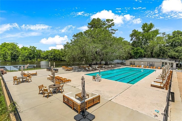 163 Tchefuncte Dr, Covington, LA 70433 - community pool featuring a water view, a patio, and view of wooded area