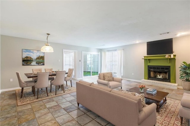 643 Stoney Creek Ave, Baton Rouge, LA 70808 - living room featuring a brick fireplace and light stone finish floors