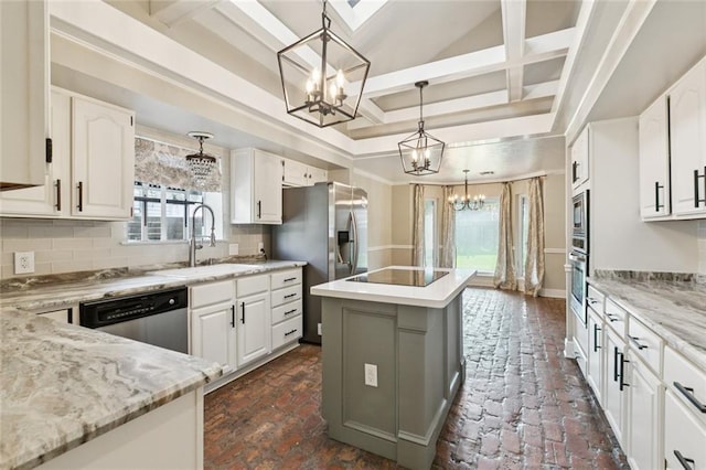 82 Melrose Dr, Destrehan, LA 70047 - kitchen featuring a chandelier, appliances with stainless steel finishes, a kitchen island, coffered ceiling, and decorative backsplash