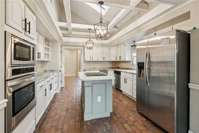 82 Melrose Dr, Destrehan, LA 70047 - kitchen featuring appliances with stainless steel finishes, a chandelier, tasteful backsplash, and a kitchen island