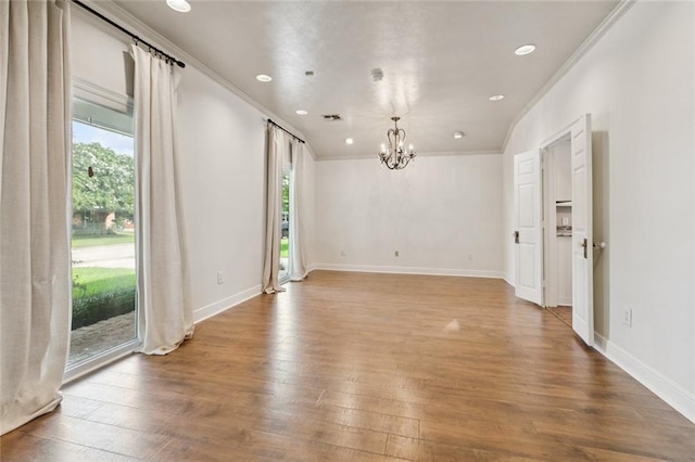 82 Melrose Dr, Destrehan, LA 70047 - unfurnished room with a chandelier, healthy amount of natural light, ornamental molding, wood finished floors, and recessed lighting