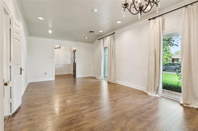 82 Melrose Dr, Destrehan, LA 70047 - empty room featuring a chandelier, wood finished floors, recessed lighting, and crown molding