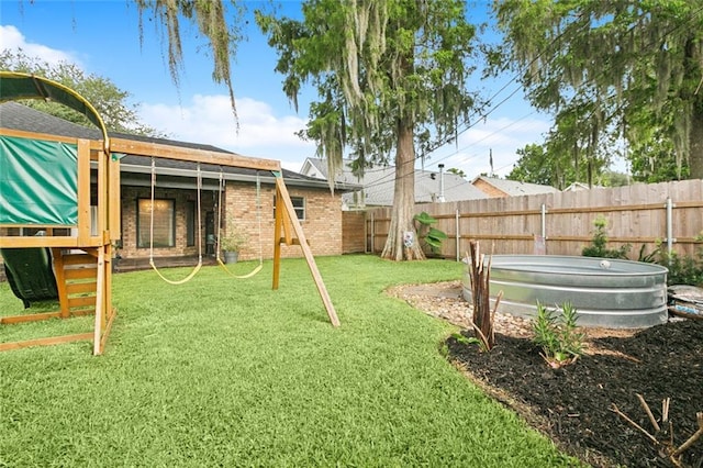 82 Melrose Dr, Destrehan, LA 70047 - fenced backyard featuring a playground