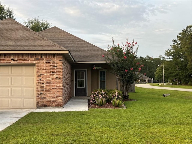 500 Buckthorne Pl, Covington, LA 70435 - view of front of house featuring a shingled roof, a front lawn, brick siding, and a garage