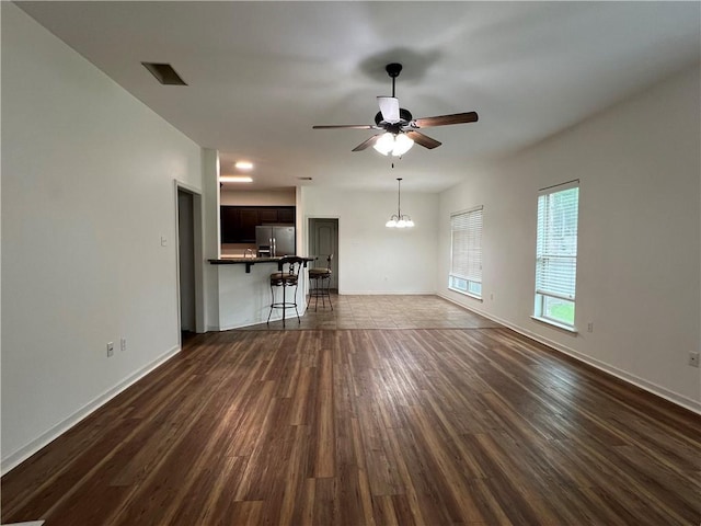 500 Buckthorne Pl, Covington, LA 70435 - unfurnished living room featuring a ceiling fan, dark wood-style floors, and a chandelier