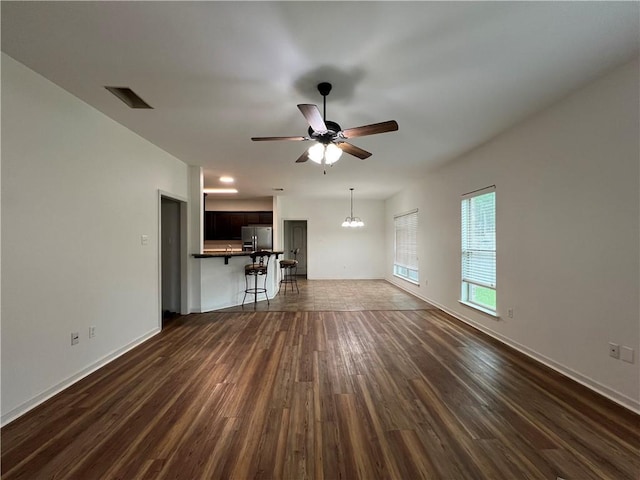 500 Buckthorne Pl, Covington, LA 70435 - unfurnished living room with a ceiling fan, dark wood-type flooring, and a chandelier