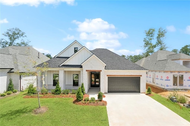 4233 Cypress Point Dr, Covington, LA 70433 - view of front of house featuring board and batten siding, a garage, driveway, a front lawn, and roof with shingles