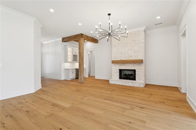 4233 Cypress Point Dr, Covington, LA 70433 - unfurnished living room with a chandelier, crown molding, light wood-style floors, recessed lighting, and a large fireplace