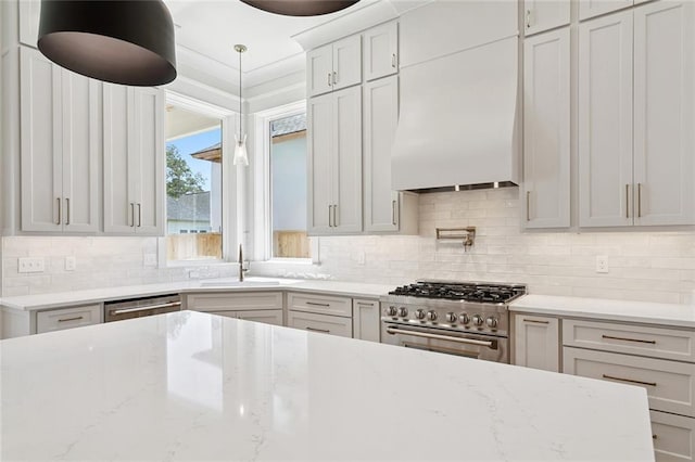 4233 Cypress Point Dr, Covington, LA 70433 - kitchen with stainless steel appliances, decorative backsplash, light stone countertops, pendant lighting, and custom exhaust hood