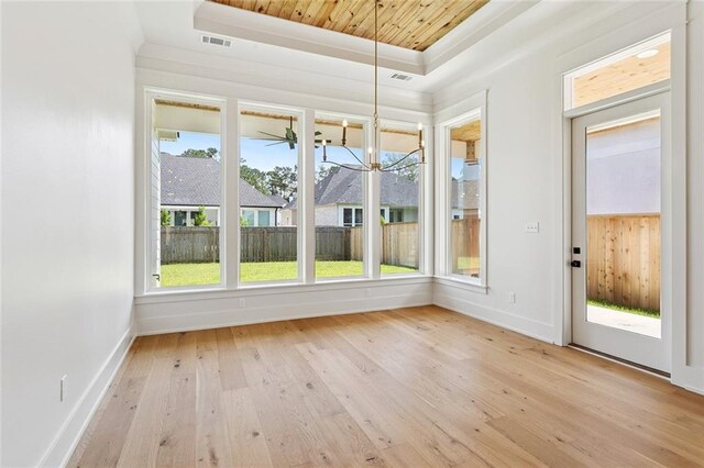 4233 Cypress Point Dr, Covington, LA 70433 - unfurnished sunroom with a tray ceiling, healthy amount of natural light, hardwood / wood-style flooring, a chandelier, and crown molding