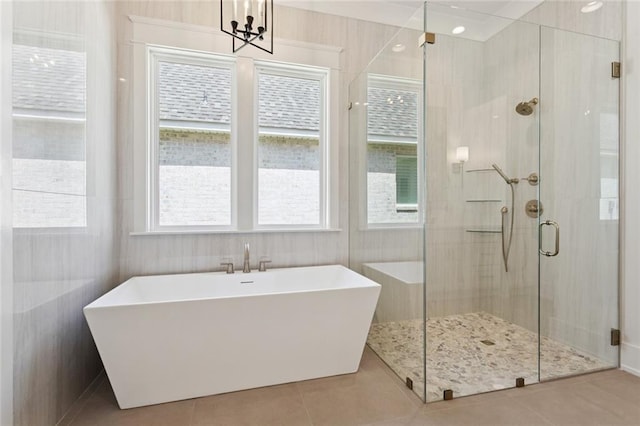 4233 Cypress Point Dr, Covington, LA 70433 - full bathroom with a soaking tub, a shower stall, a chandelier, and tile patterned flooring