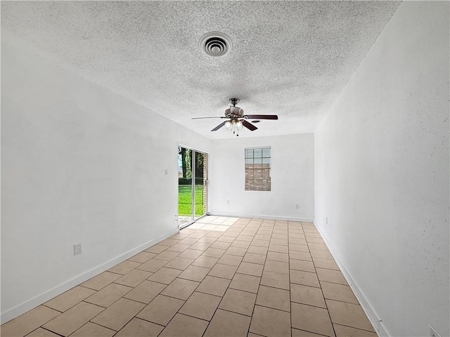 1024 Marshall Dr, Marrero, LA 70072 - spare room featuring a textured ceiling, a ceiling fan, and light tile patterned floors