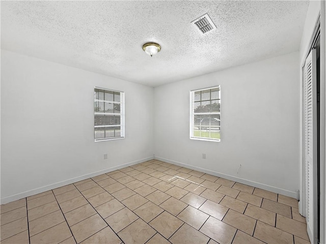 1024 Marshall Dr, Marrero, LA 70072 - unfurnished room featuring a textured ceiling and light tile patterned floors