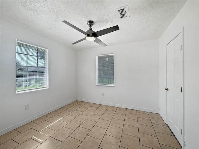 1024 Marshall Dr, Marrero, LA 70072 - spare room with a textured ceiling, ceiling fan, and light tile patterned floors