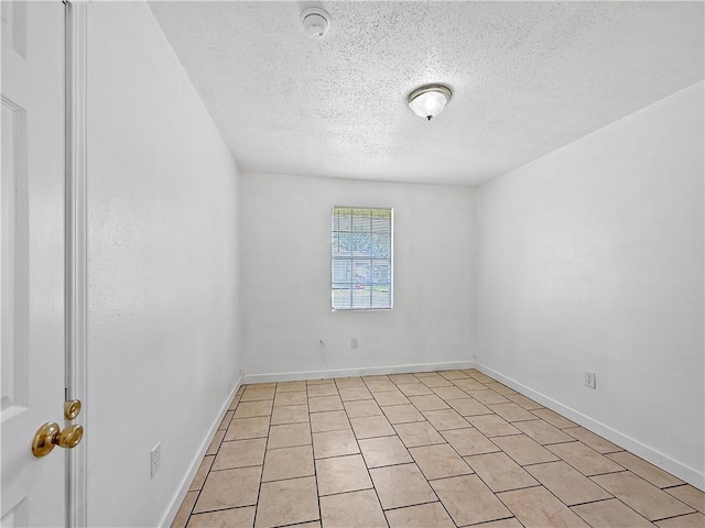 1024 Marshall Dr, Marrero, LA 70072 - empty room with a textured ceiling and light tile patterned floors