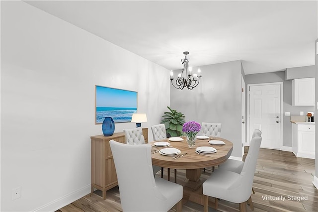 721 Heavens Dr Unit 6, Mandeville, LA 70471 - dining room with a chandelier and light wood-style floors