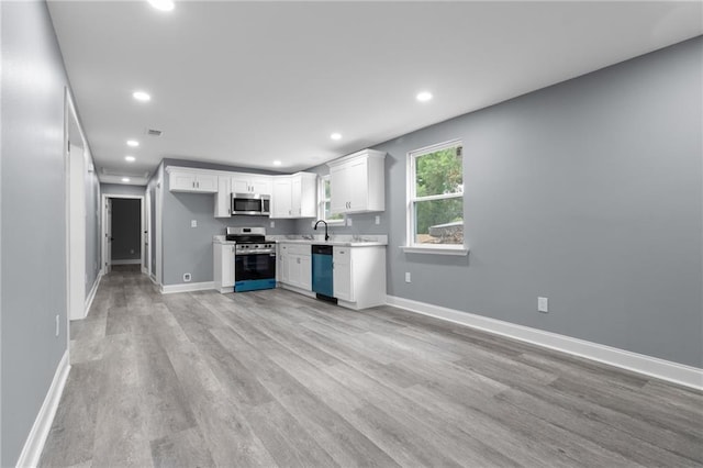 162628 Numa St, New Orleans, LA 70114 - kitchen featuring appliances with stainless steel finishes, recessed lighting, light wood-type flooring, white cabinetry, and light countertops