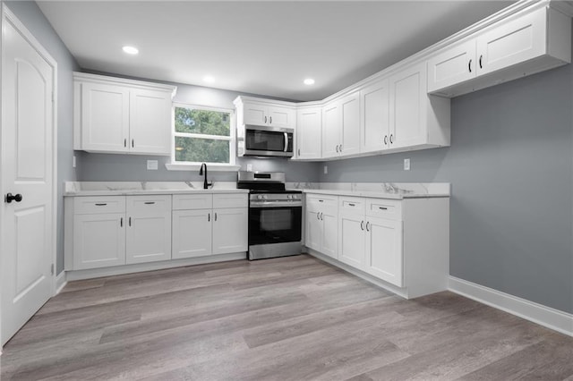 162628 Numa St, New Orleans, LA 70114 - kitchen with stainless steel appliances, white cabinets, recessed lighting, and light wood-type flooring