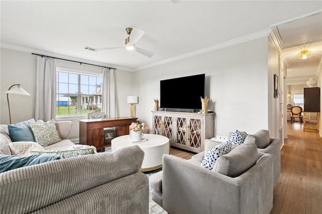 143 Vans Ln, Destrehan, LA 70047 - living room featuring crown molding, wood finished floors, a ceiling fan, and attic access