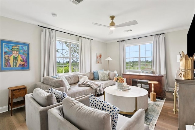 143 Vans Ln, Destrehan, LA 70047 - living room with healthy amount of natural light, wood finished floors, ornamental molding, and a ceiling fan