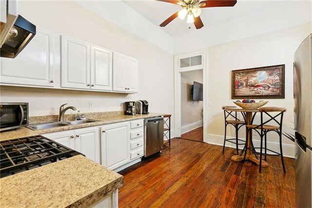 332426 Banks St, New Orleans, LA 70119 - kitchen with stainless steel appliances, extractor fan, a ceiling fan, white cabinetry, and light countertops
