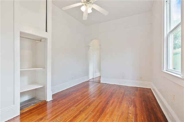 332426 Banks St, New Orleans, LA 70119 - unfurnished room with hardwood / wood-style floors, a ceiling fan, arched walkways, and crown molding