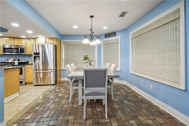213 Chimaera Ln, Slidell, LA 70458 - dining area featuring a chandelier, recessed lighting, and brick floors