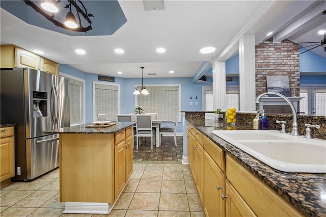 213 Chimaera Ln, Slidell, LA 70458 - kitchen with stainless steel fridge, a kitchen island, dark stone counters, hanging light fixtures, and light tile patterned floors