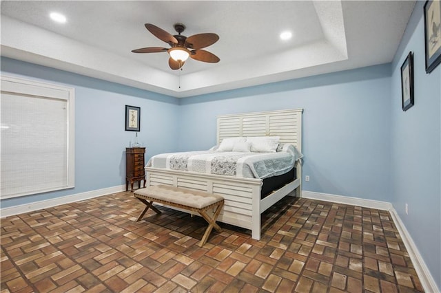 213 Chimaera Ln, Slidell, LA 70458 - bedroom featuring a tray ceiling, brick flooring, ceiling fan, and recessed lighting