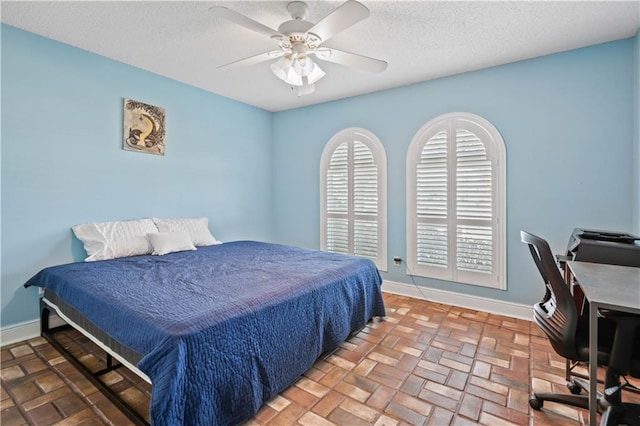 213 Chimaera Ln, Slidell, LA 70458 - bedroom with a textured ceiling, a ceiling fan, and brick flooring