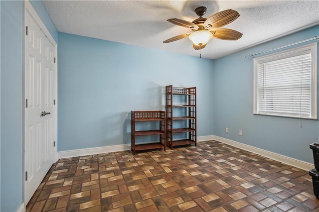 213 Chimaera Ln, Slidell, LA 70458 - bedroom featuring brick patterned floors, a closet, a textured ceiling, and ceiling fan