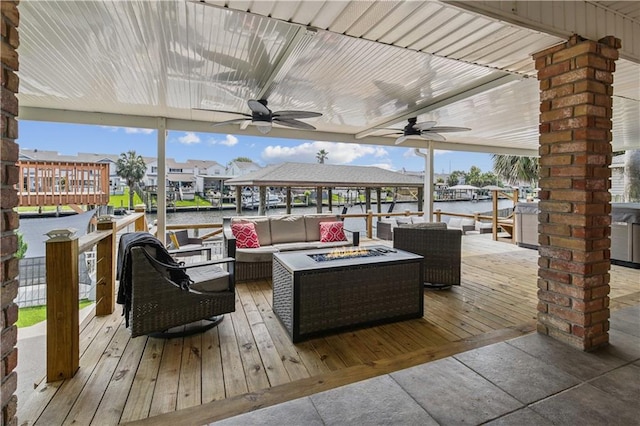 213 Chimaera Ln, Slidell, LA 70458 - wooden terrace with ceiling fan, an outdoor living space with a fire pit, a water view, and a gazebo